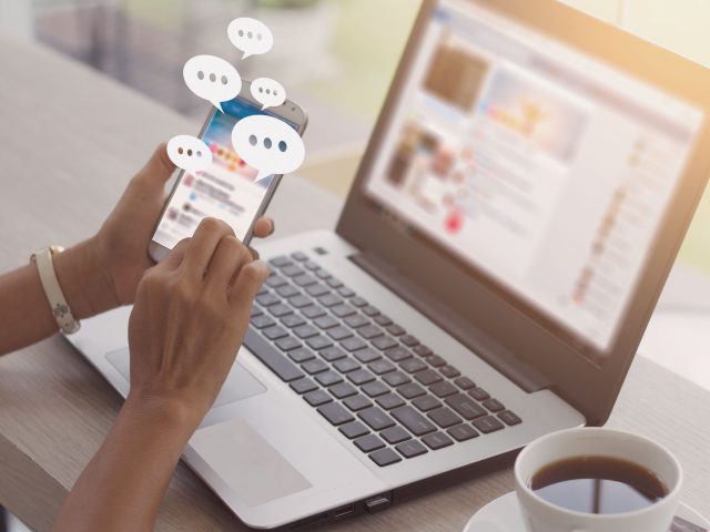 browsing social media on phone and laptop